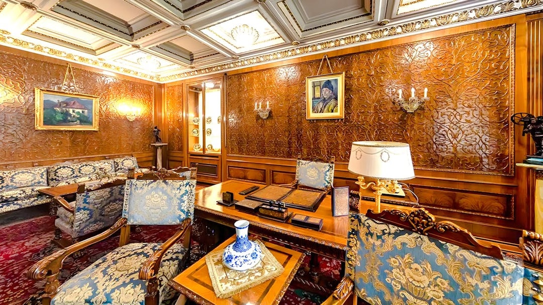 Interior of Ceaușescu Mansion in Bucharest with ornate wood paneling and vintage furniture.