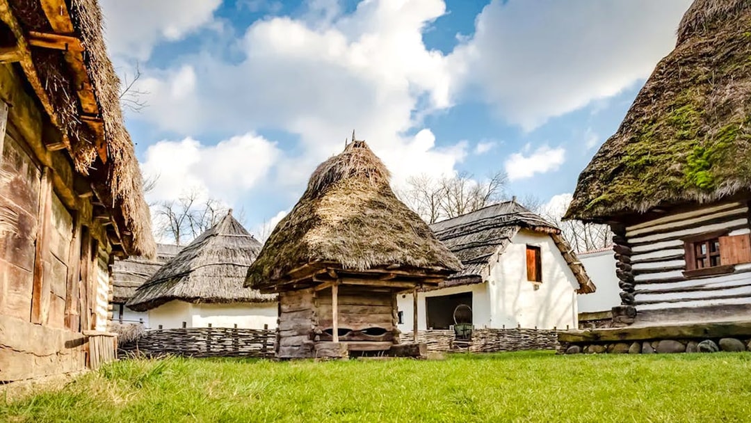 Traditional thatched-roof houses at Dimitrie Gusti National Village Museum, Bucharest.
