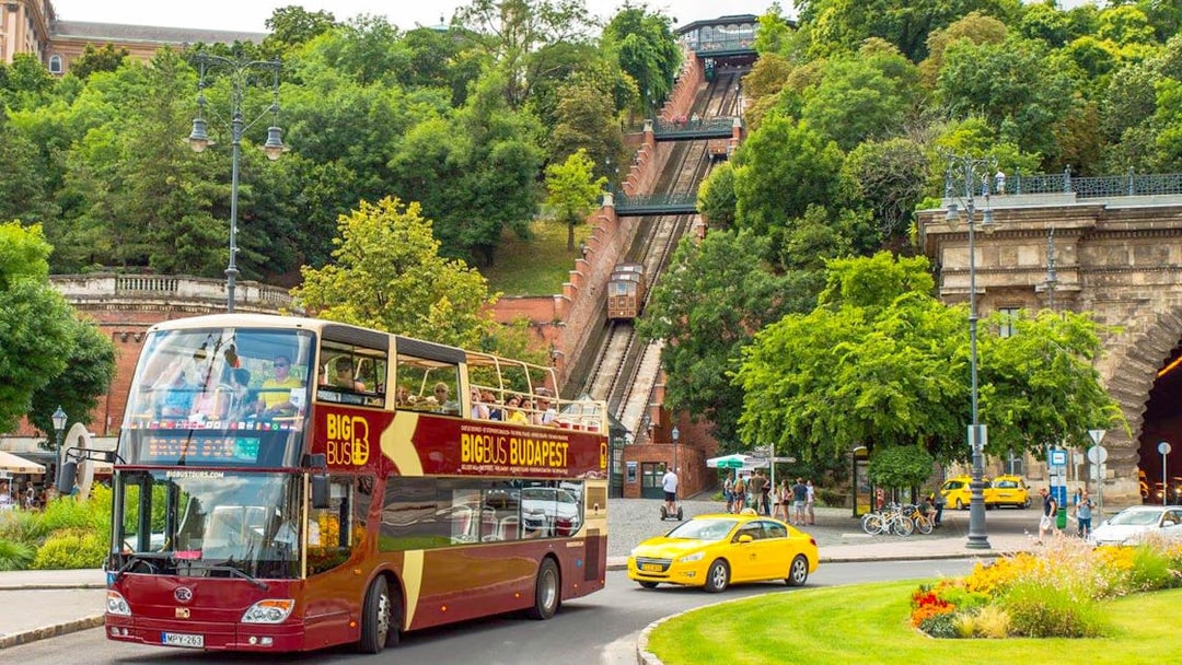 Budapest Big Bus tour near the funicular, with passengers enjoying the view.