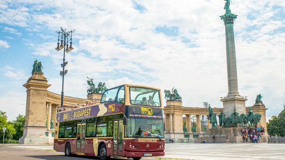 Hop-On Hop-Off bus in front of Millennium Monument, Budapest.