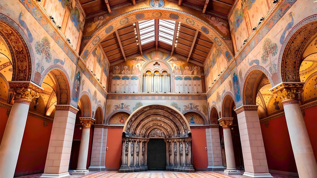 Interior of the Museum of Fine Arts in Budapest, featuring ornate arches and detailed frescoes.