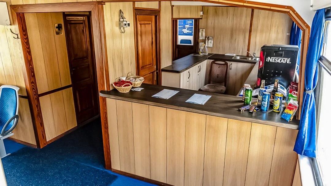 Interior of a Danube River cruise boat with a snack bar and seating area.