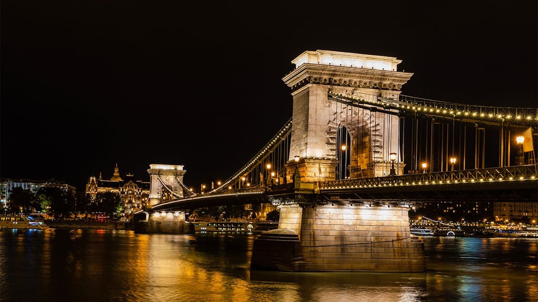 Szechenyi Chain Bridge illuminated at night viewed from a Budapest Danube River dinner cruise.