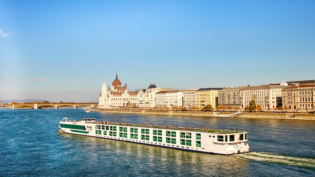 Cruise ship on the Danube River with Budapest Parliament in the background.