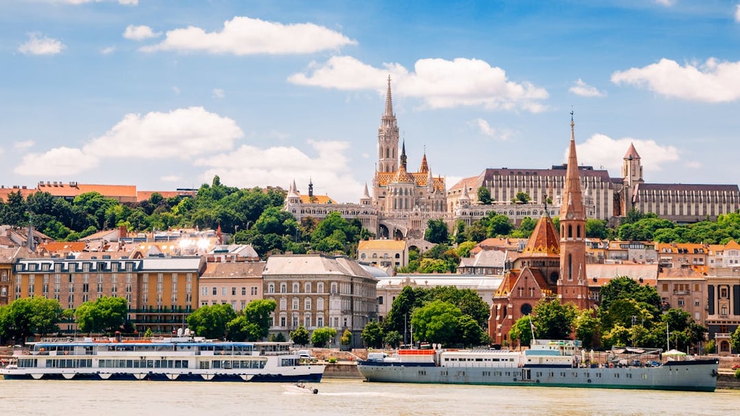Danube River cruise passing Fisherman's Bastion and Matthias Church in Budapest.