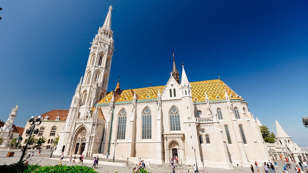 Matthias Church in Budapest with colorful roof and tall spire, seen on a day trip from Vienna.