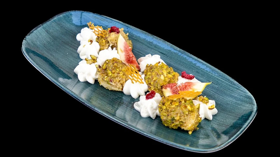 Pistachio-crusted dessert with figs and cream on Budapest Dinner Cruise.