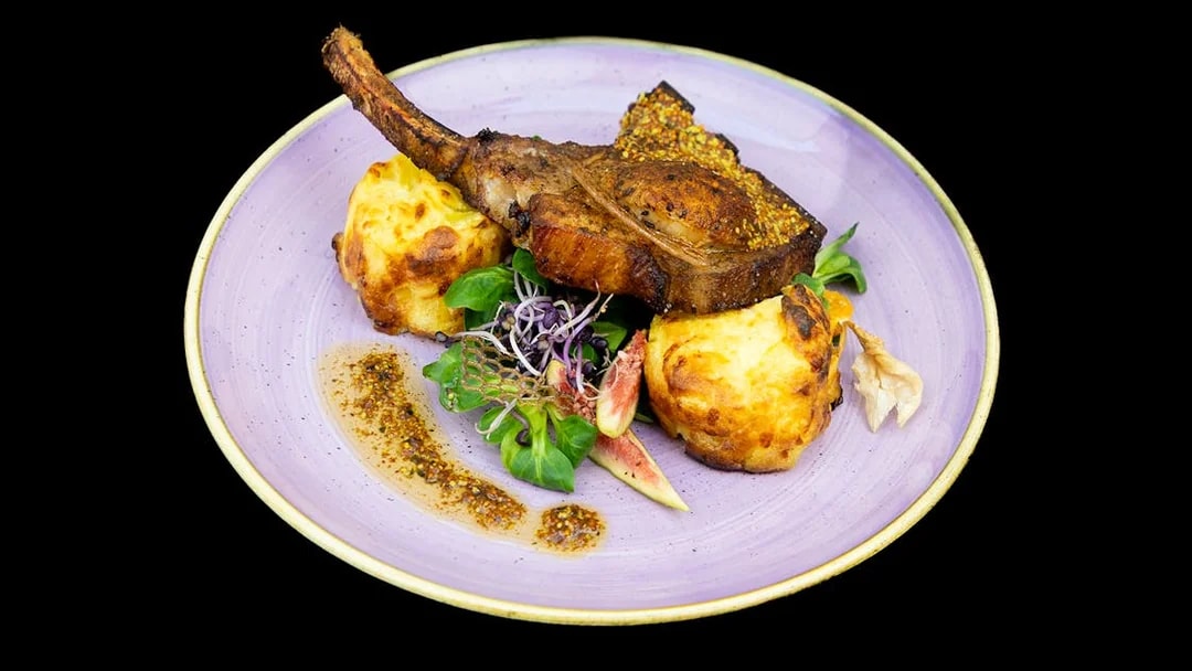 Grilled lamb chop with mashed potato and fig garnish on Budapest Dinner Cruise.