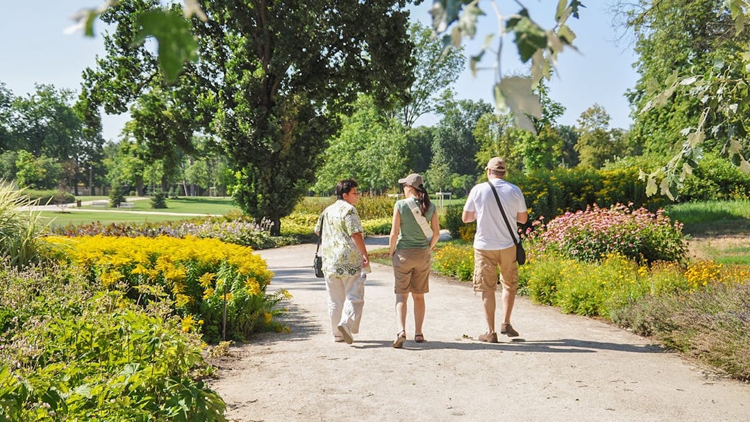 Visitors walking through gardens on the Gödöllő Royal Sisi tour near Budapest.