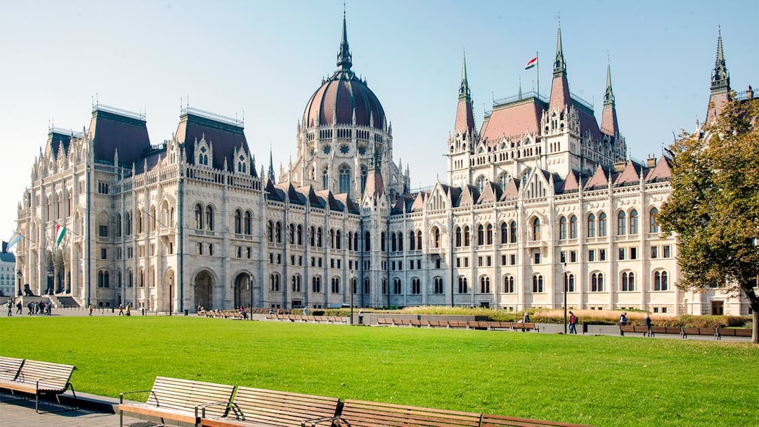 Hungarian Parliament building with green lawn, part of Grand City Tour.