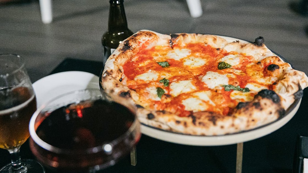 Pizza with drinks on Trastevere Food Tour in Rome.