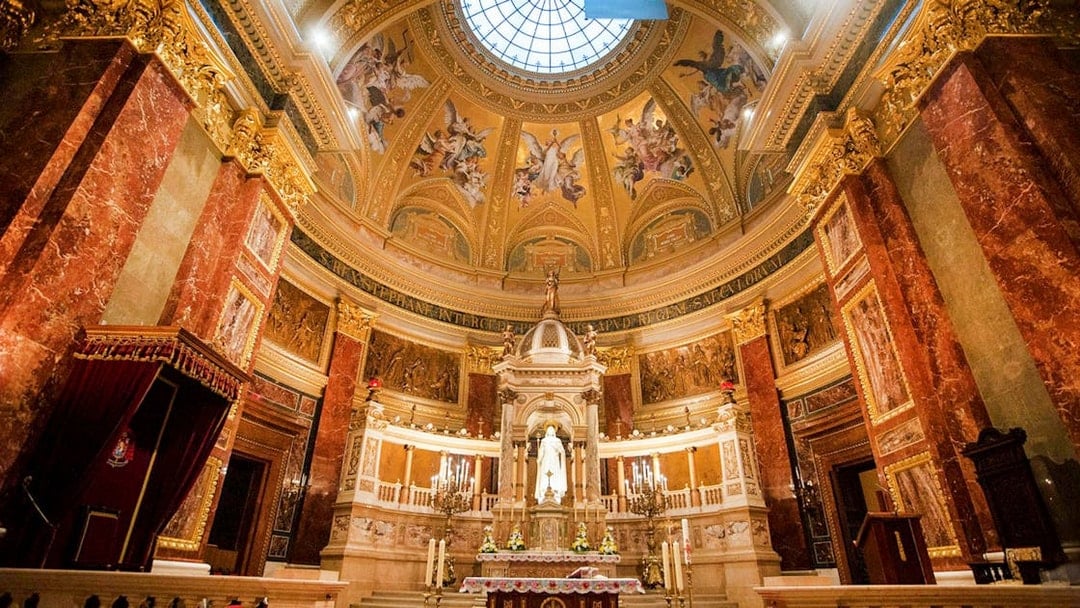 Interior view of St. Stephen's Basilica in Budapest, showcasing ornate dome and altar.