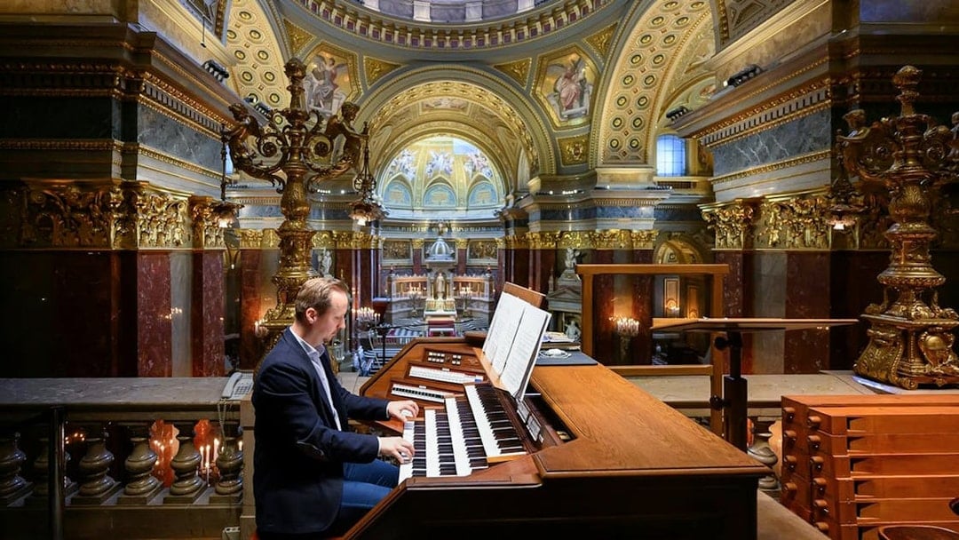 Musician playing the organ inside St. Stephen's Basilica, Budapest.
