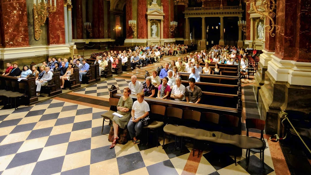 Guests seated in St. Stephen's Basilica for a live organ concert in Budapest.