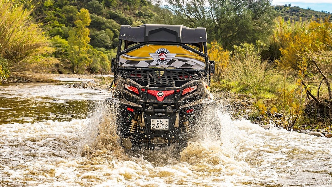 Buggy crossing a river in Algarve countryside during a tour.