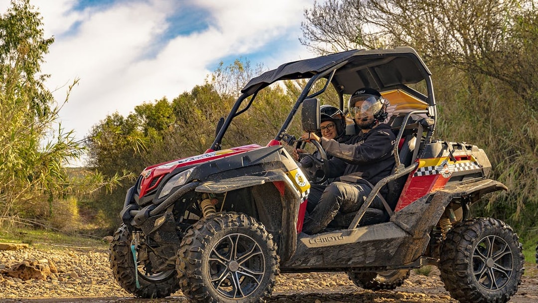 Buggy driving on rocky terrain during Algarve tour.