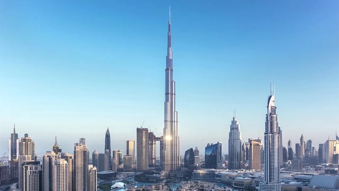 Aerial view of Burj Khalifa with Dubai cityscape in the background.