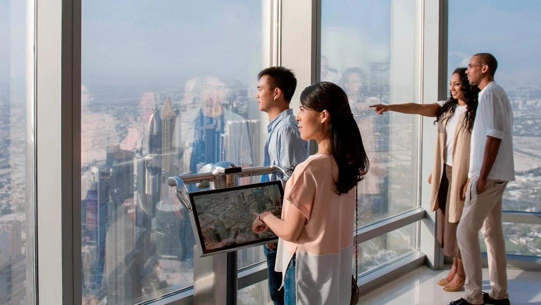 Tourists viewing Dubai skyline from Burj Khalifa Levels 124 and 125.