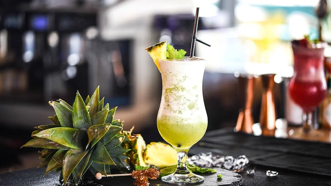 Mocktail with pineapple garnish at Burj Khalifa At the Top, Levels 124-125.