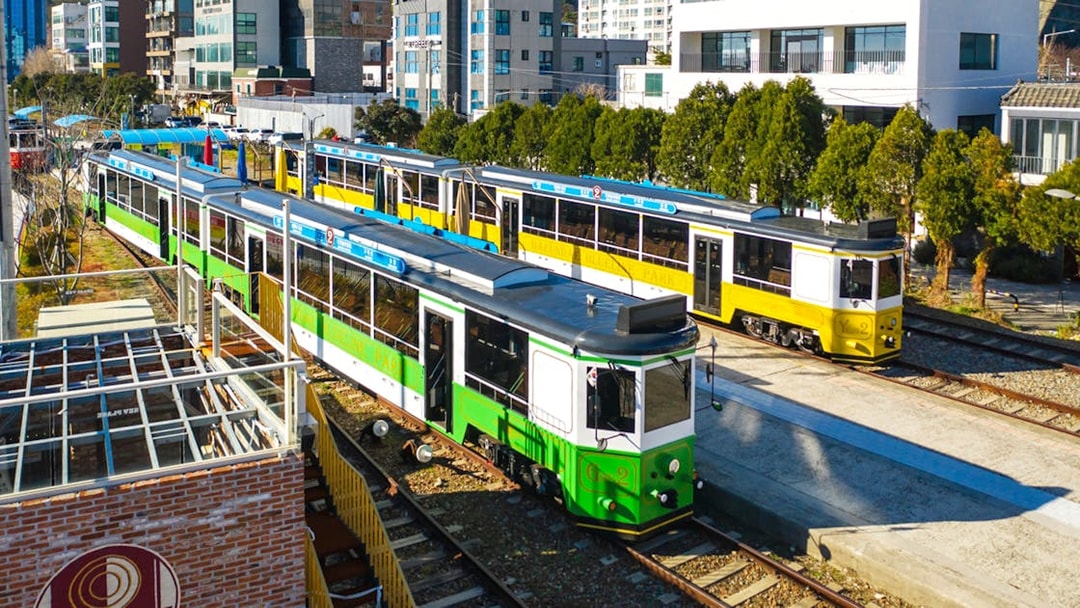 Blueline Park Sky Capsule trains in Busan cityscape during one-day city tour.