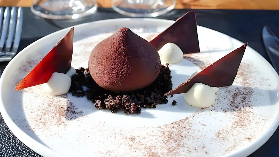 Chocolate dessert with mousse and shards on Bustronome Paris tour.