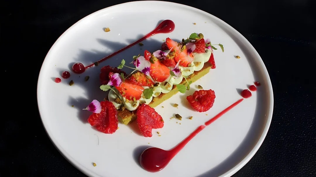 Gourmet dessert with strawberries and raspberries on Bustronome Paris tour.