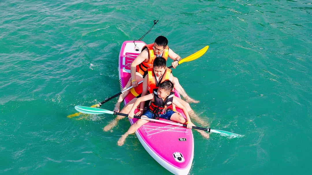 Family paddling on a boat during Langkawi Sunset Cruise.
