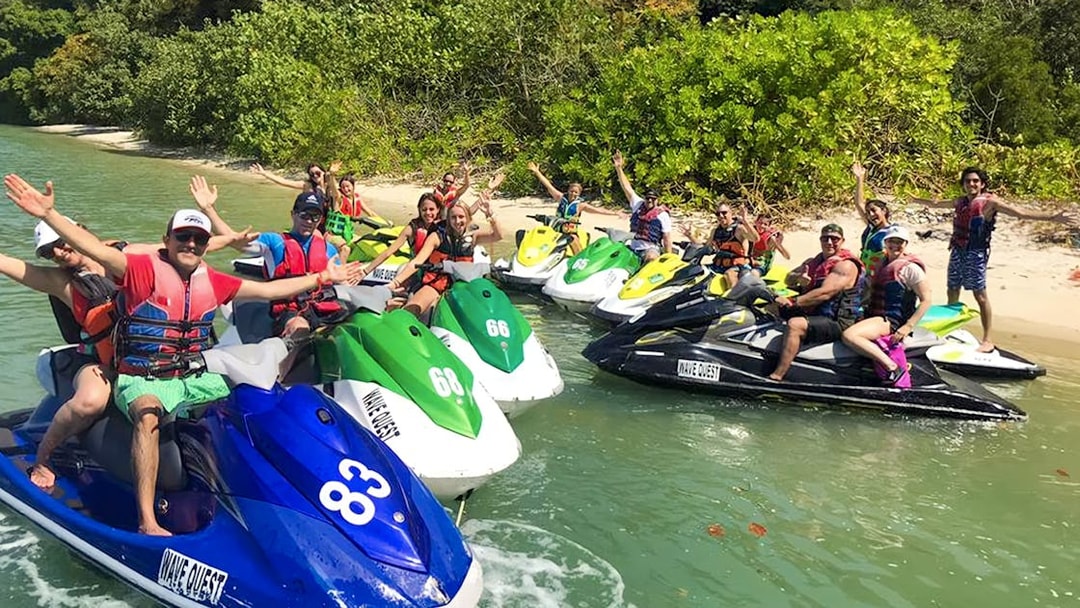 Group enjoying jet ski tour near lush island in Langkawi.