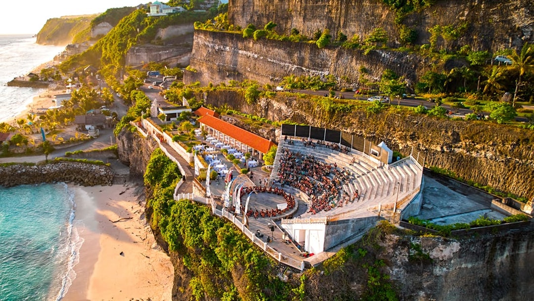 Kecak and Fire Dance Show amphitheater at Melasti Beach, Bali, with ocean view.