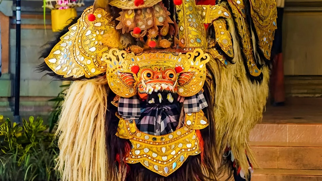 Ubud Kecak dance costume with intricate gold detailing and traditional mask.