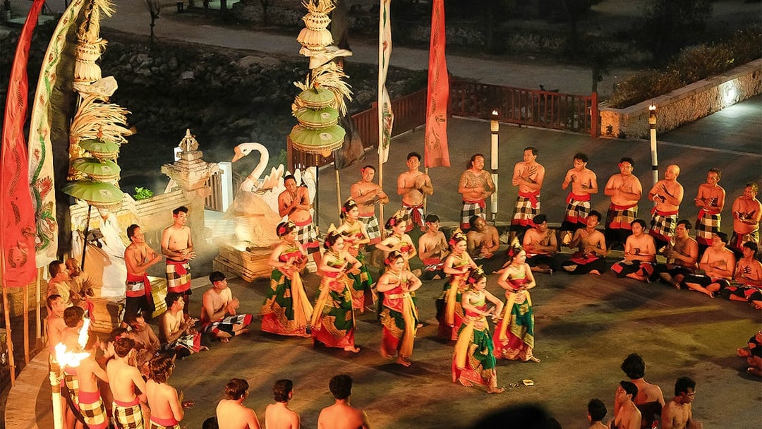 Kecak and Fire Dance performance by the beach in Bali, featuring traditional costumes and chanting circle.