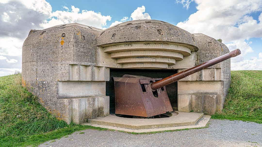 World War II bunker with artillery gun at Normandy D-Day landing site.