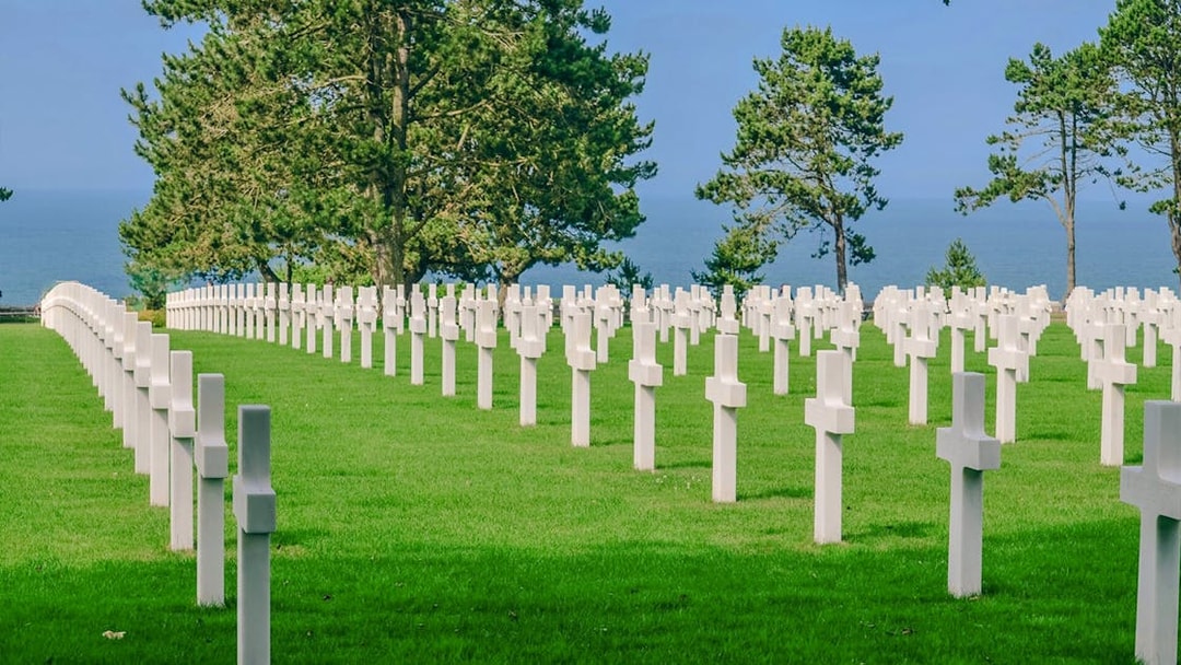 Rows of white crosses at Normandy American Cemetery, overlooking the sea in Caen, France.