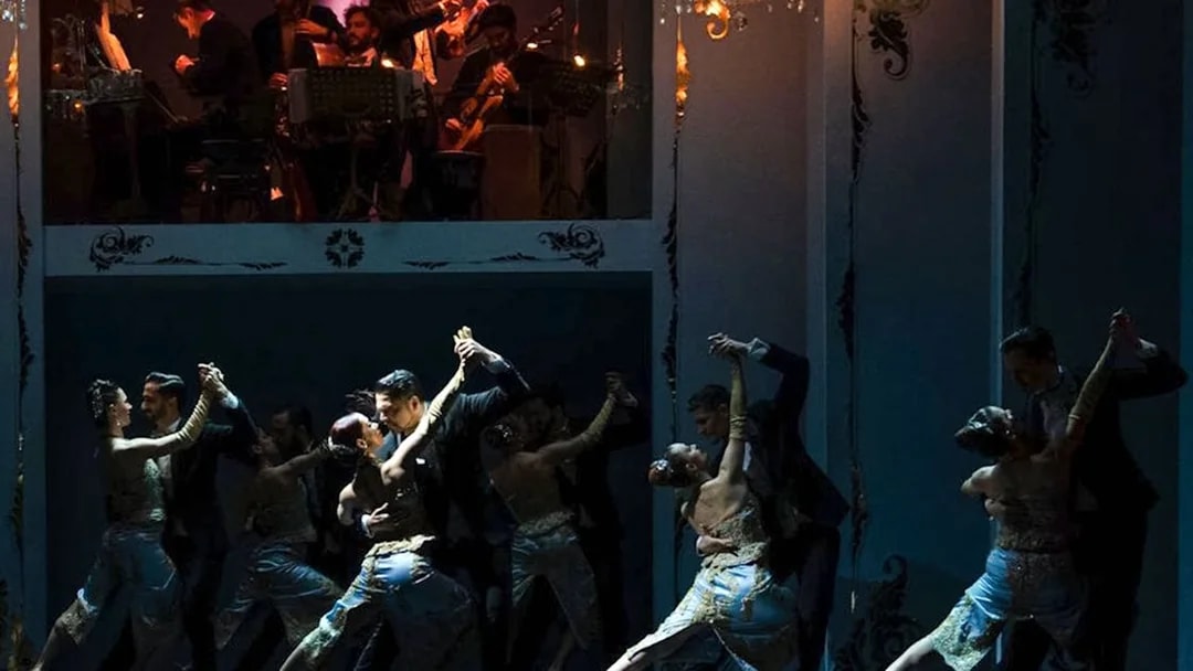 Tango dancers performing at Café de los Angelitos with live musicians in Buenos Aires.