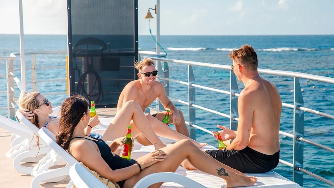 Tourists relaxing on a sundeck of a pontoon at the Great Barrier Reef.