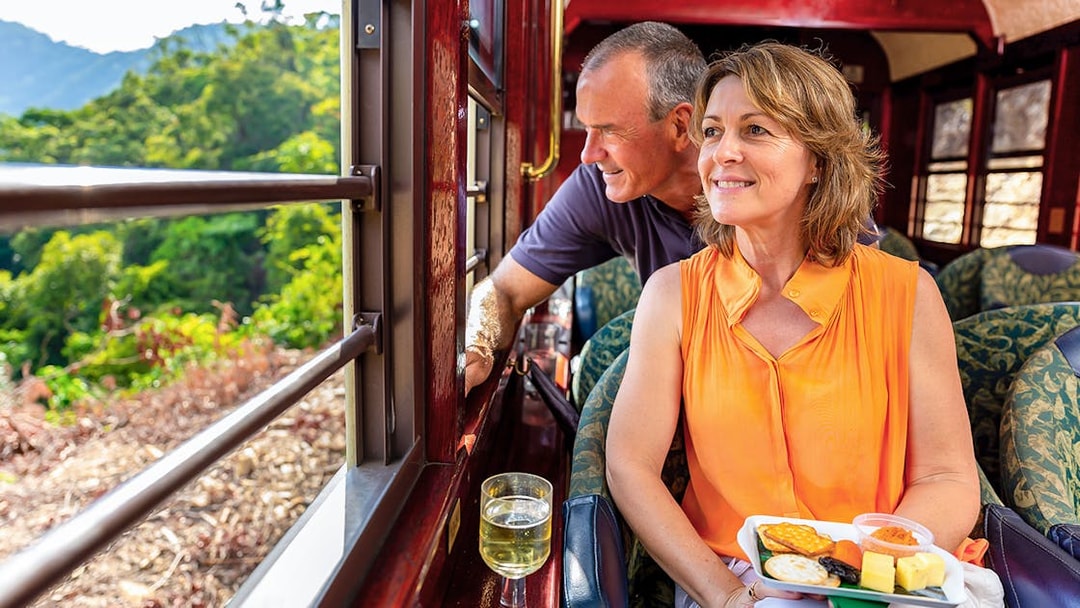 Kuranda Railway Gold Class passengers enjoying scenic view and refreshments, Cairns.