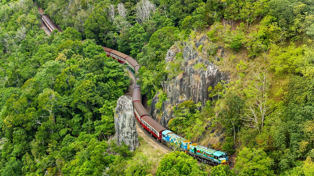 Kuranda Scenic Railway winding through lush rainforest in Queensland.