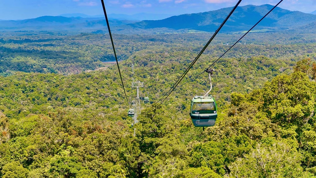 Kuranda Skyrail Rainforest Cableway gliding over lush forest canopy in Queensland, Australia.