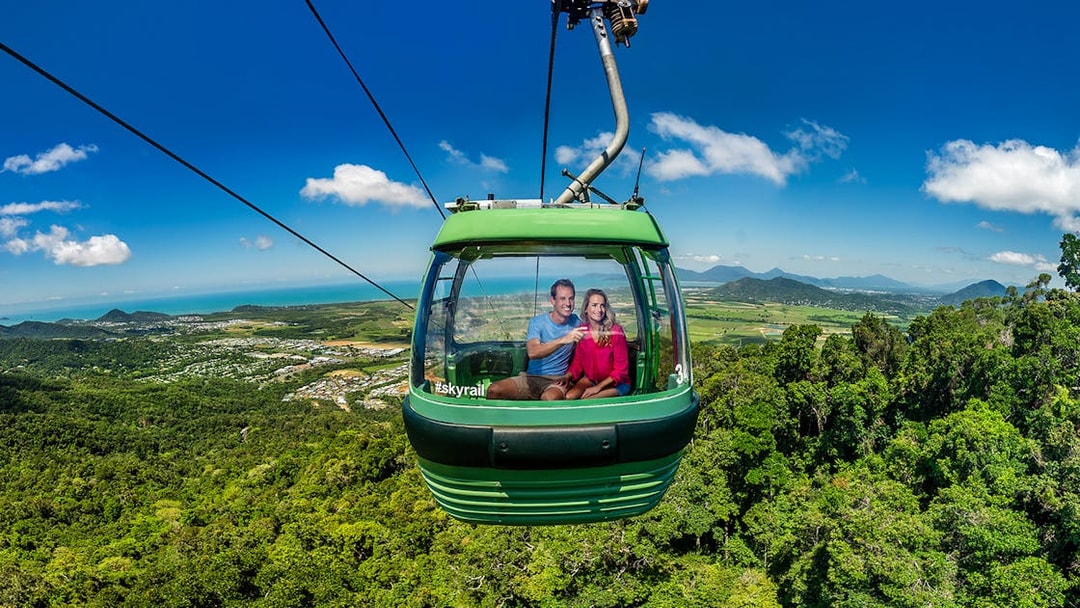 People enjoying the view from a cable car on the Kuranda Skyrail Rainforest Cableway.