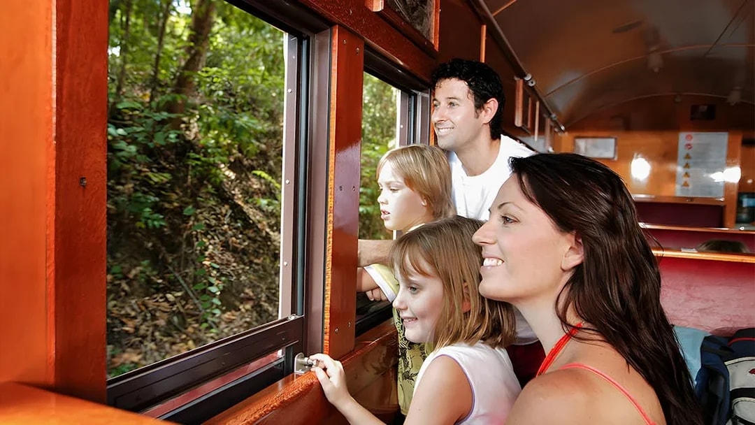 Family enjoying views from Kuranda Scenic Railway heritage train.