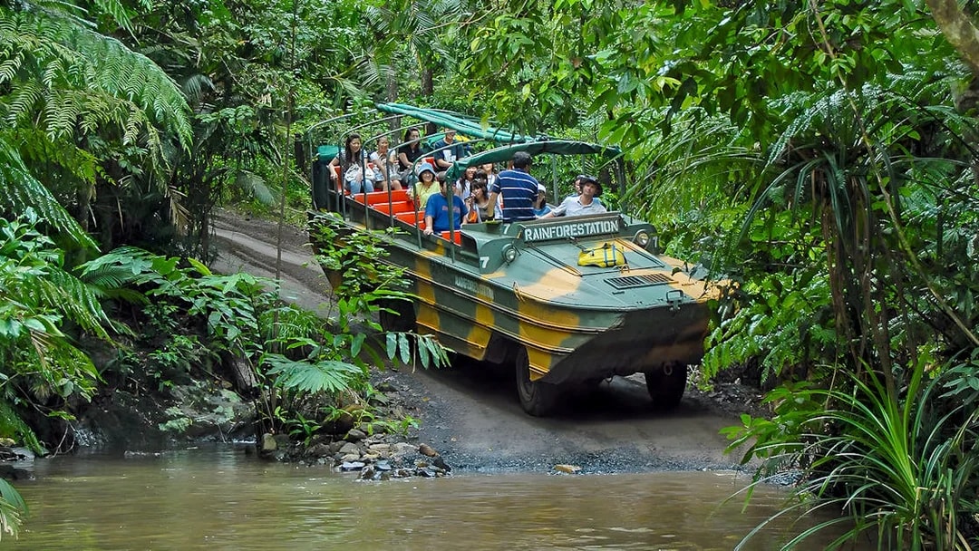 Tourists on an Army Duck vehicle exploring Kuranda rainforest, Queensland.