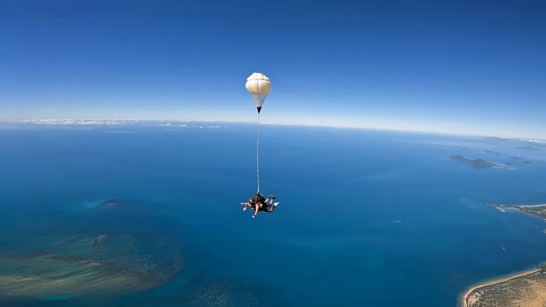 Tandem skydive over Cairns with view of ocean and coastline.