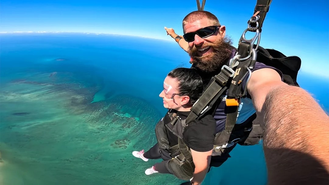 Tandem skydive over Great Barrier Reef, Cairns, with clear blue skies.