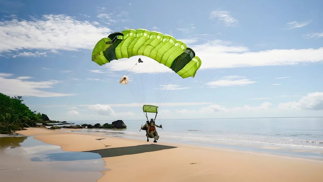 Tandem skydive landing on a beach in Cairns, Australia.