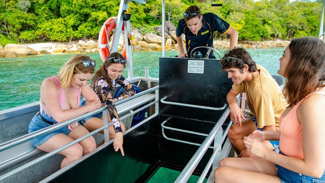 People enjoying a glass bottom boat tour near Fitzroy Island.