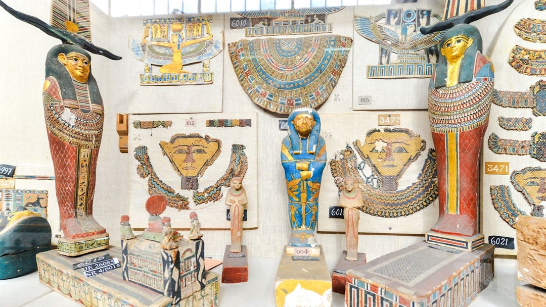 Ancient Egyptian artifacts displayed inside a museum exhibit.