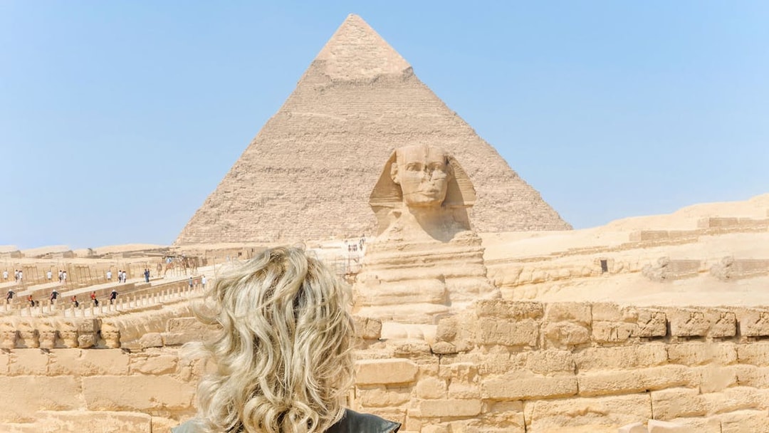 Tourist viewing the Sphinx and Pyramid of Giza in Egypt.