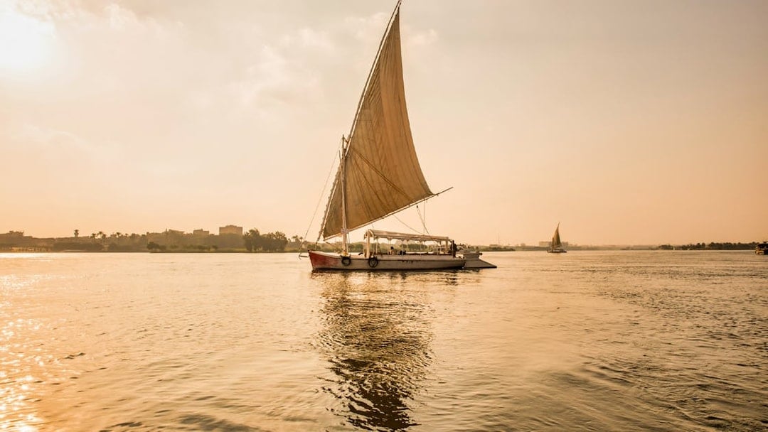 Felucca sailing on the River Nile during sunset in Egypt.