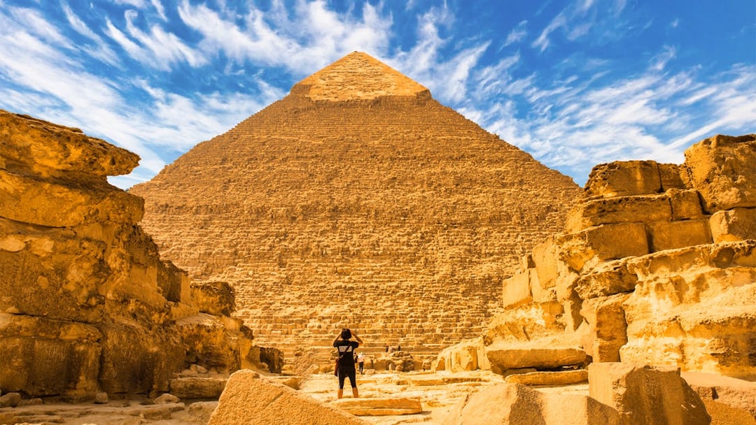 Pyramid of Giza with a person standing in front, Egypt tour experience.