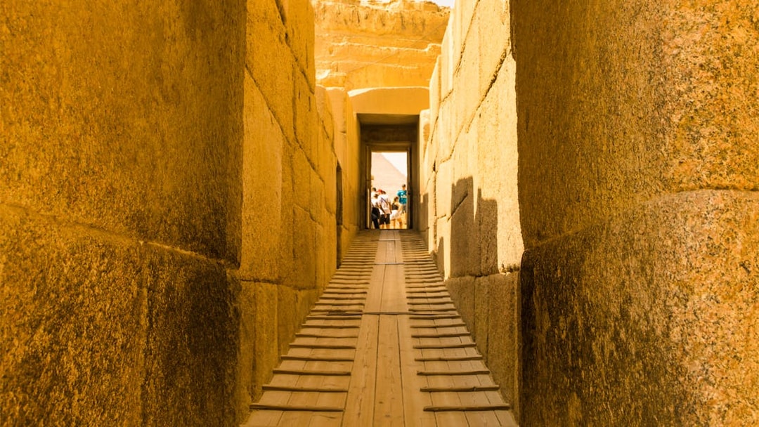 Pathway through ancient stone corridor leading to the Pyramids, Egypt.